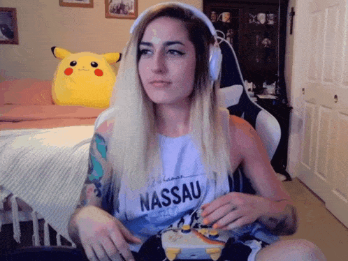 a woman wearing headphones and a nassau tank top