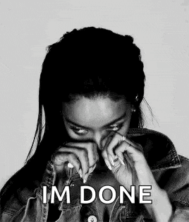 a black and white photo of a woman covering her face with her hands and the words `` i 'm done '' above her .