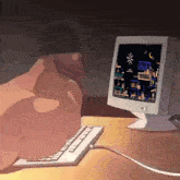 a person is typing on a keyboard next to a computer screen